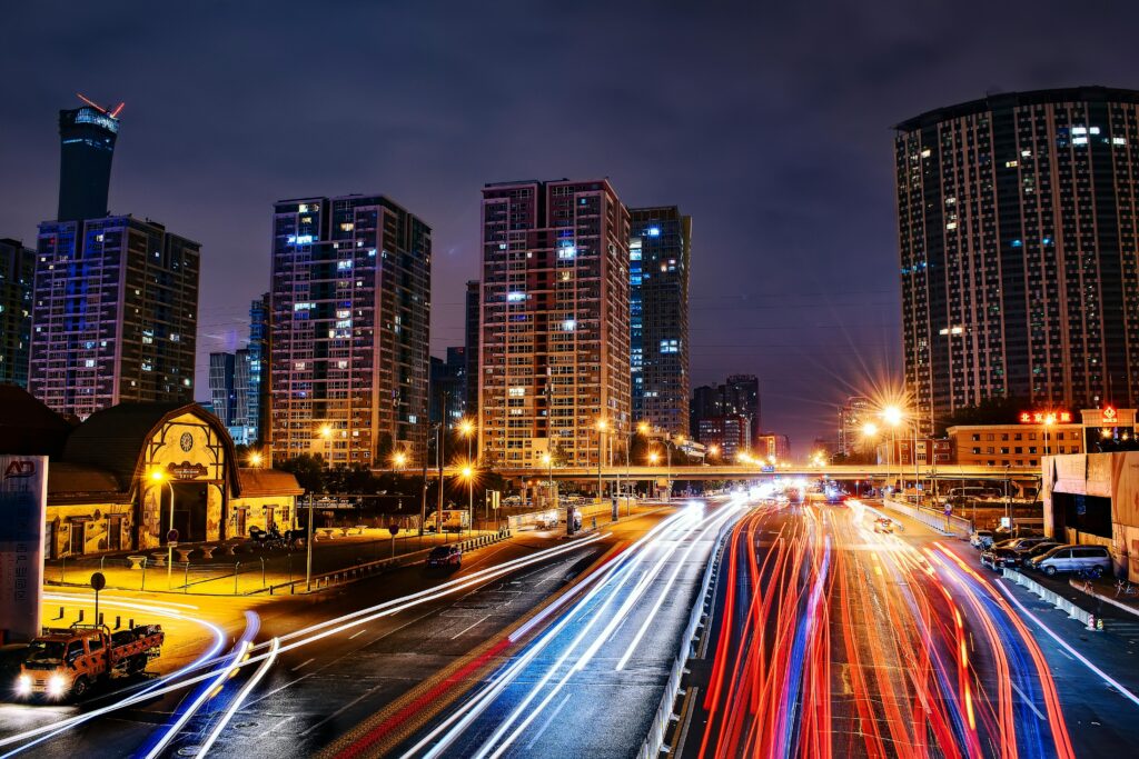 Vibrant long exposure night cityscape in Beijing showcasing urban lights and skyscrapers.