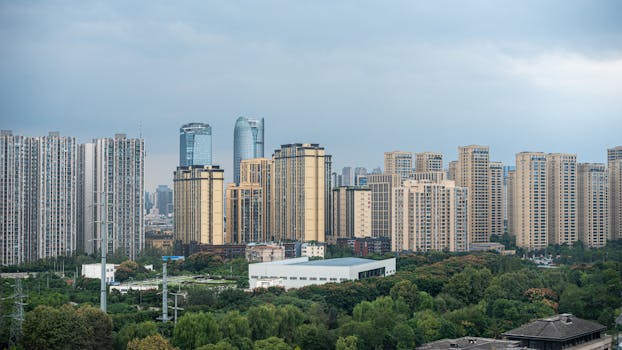 A stunning view of Chengdu's skyline featuring modern skyscrapers and lush greenery under a cloudy sky.