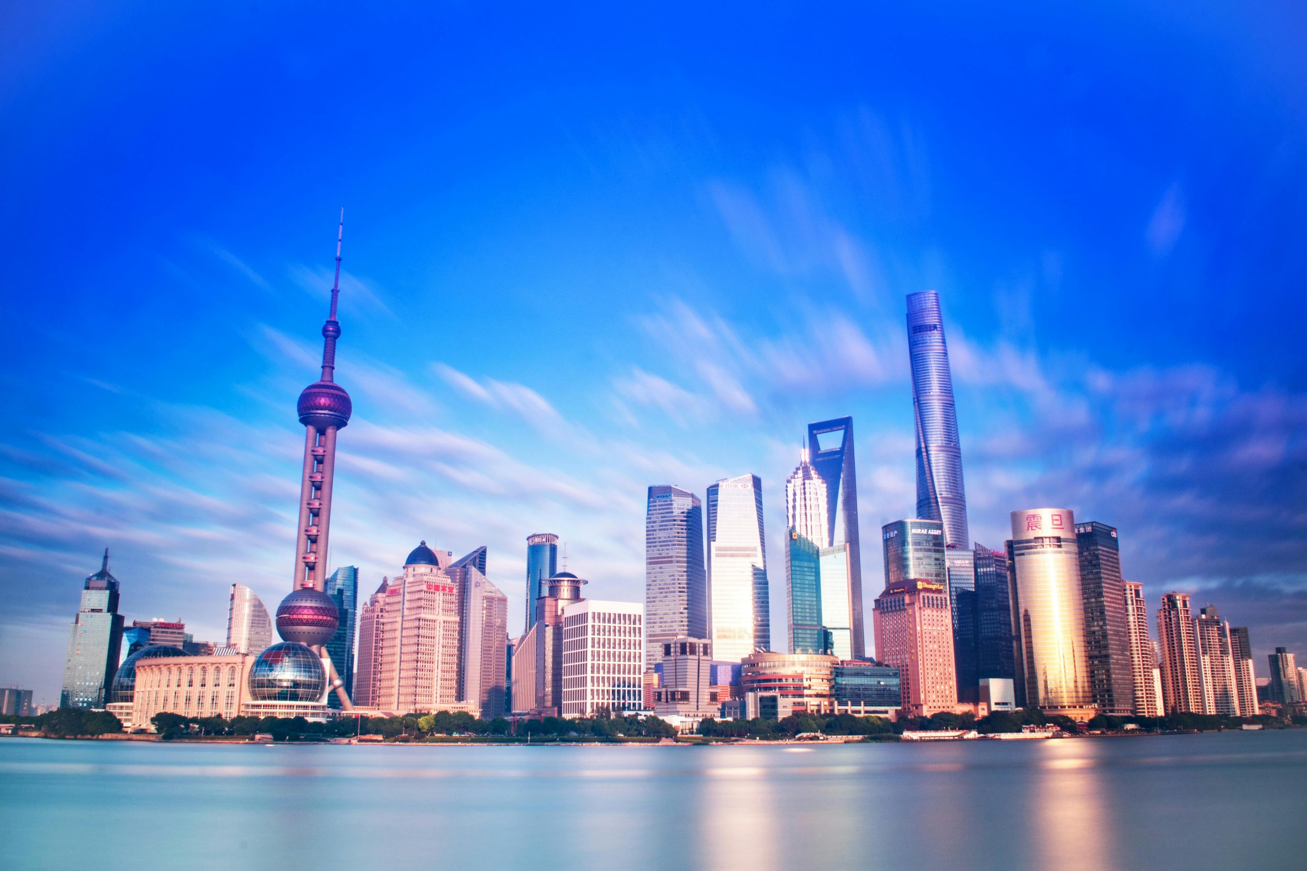 Vibrant Shanghai skyline featuring the iconic Oriental Pearl Tower and modern skyscrapers.